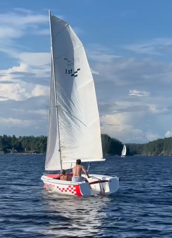 En liten seiljolle på fjorden